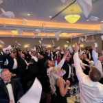 singing waiters get guests to throw napkins in the air