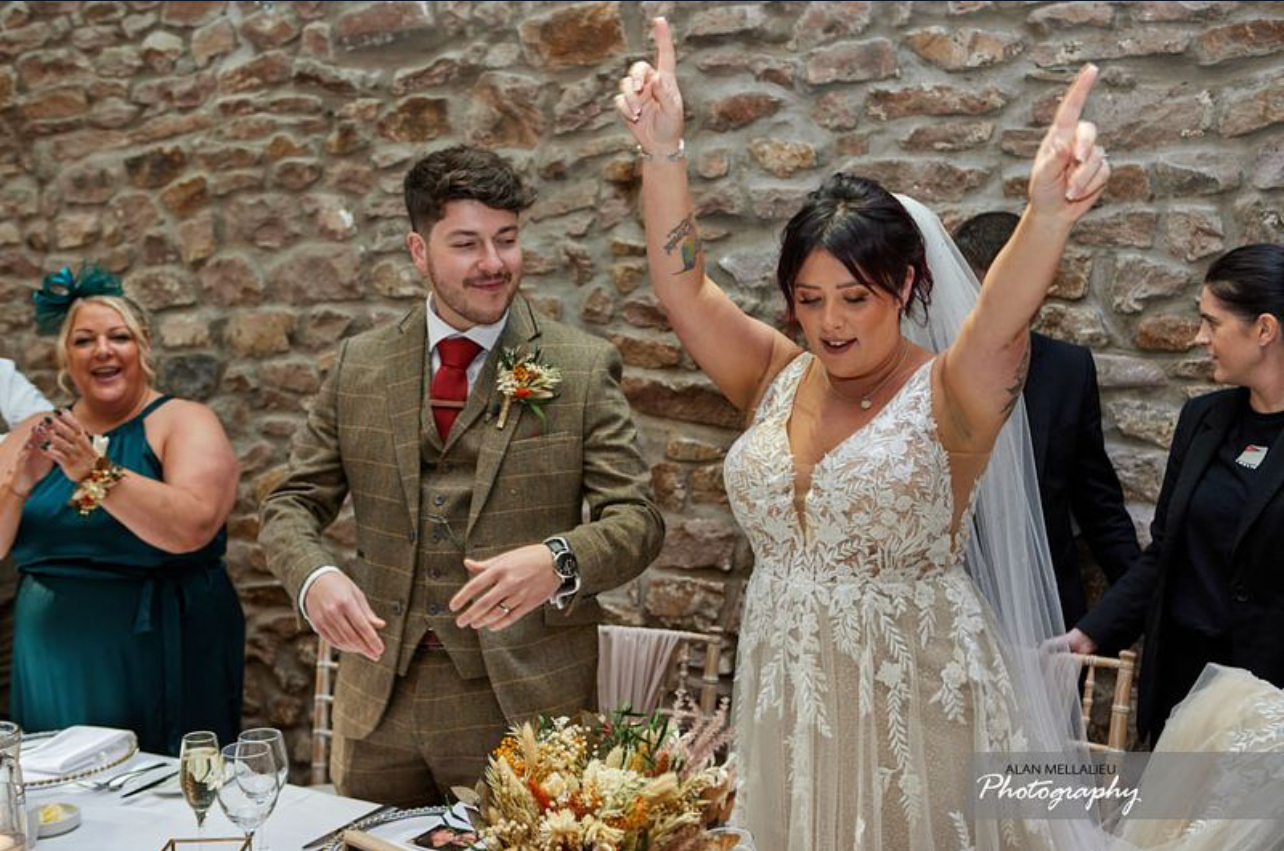Bride dancing with her Groom and Silver Service Singers Singing Waiters