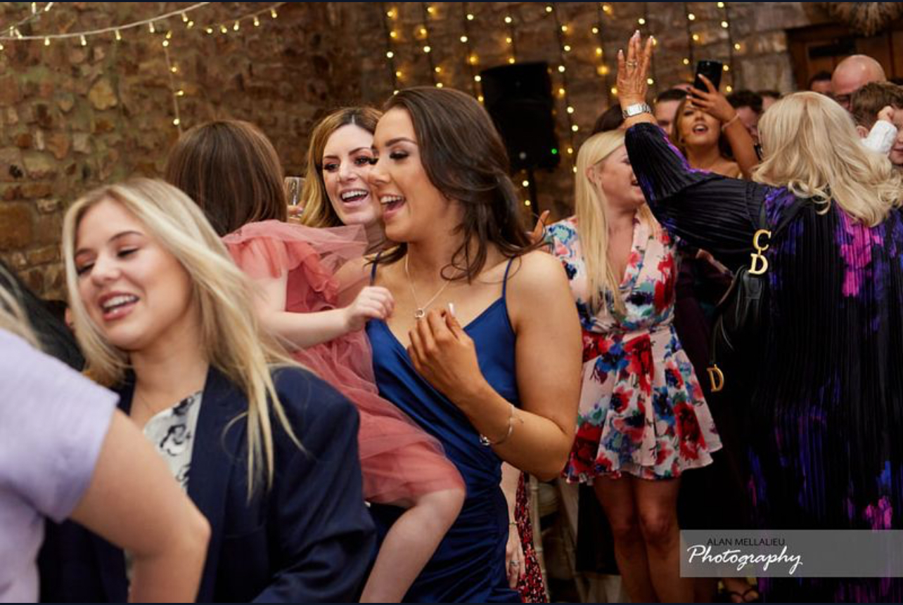 Guests taking part in a conga line with Silver Service Singing Waiters