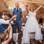 Bride and Groom up on their chairs with Silver Service Singers