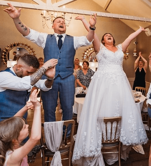 Bride and Groom up on their chairs with Silver Service Singers