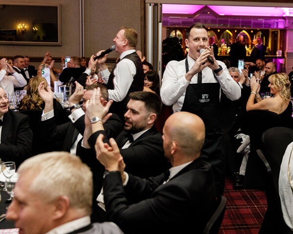 Two Singing Waiters performing at a dinner event - Silver Service Singing Waiters