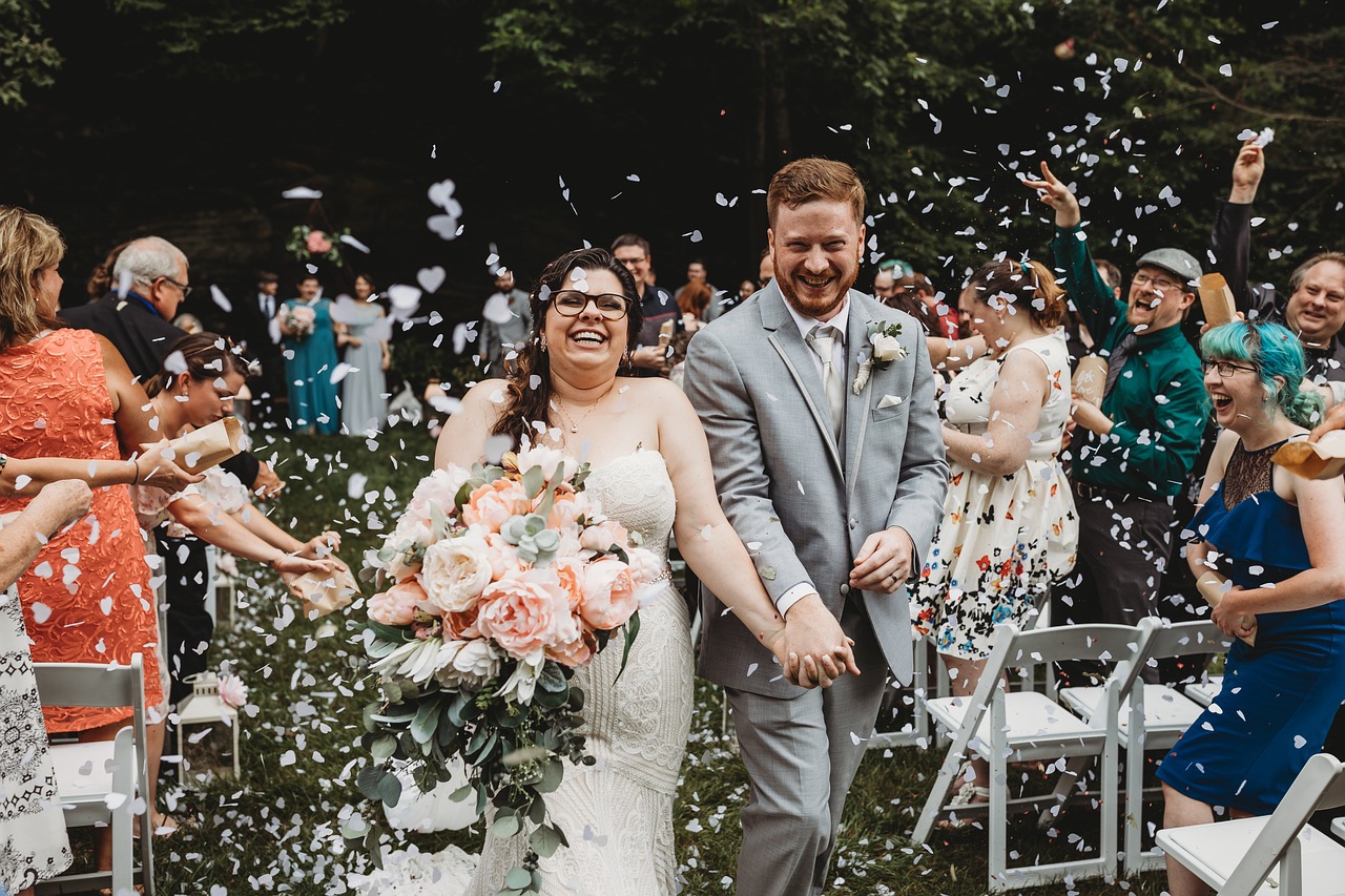 Newly weds walking down the aisle through a confetti shower