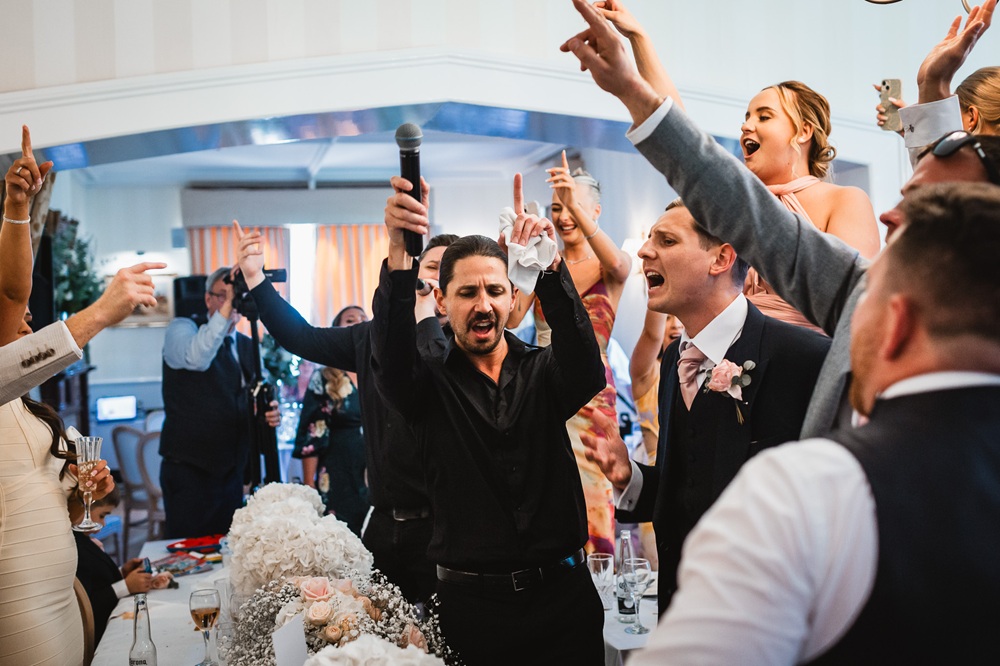 Singing Waiter sings and dances through the guests at a wedding.