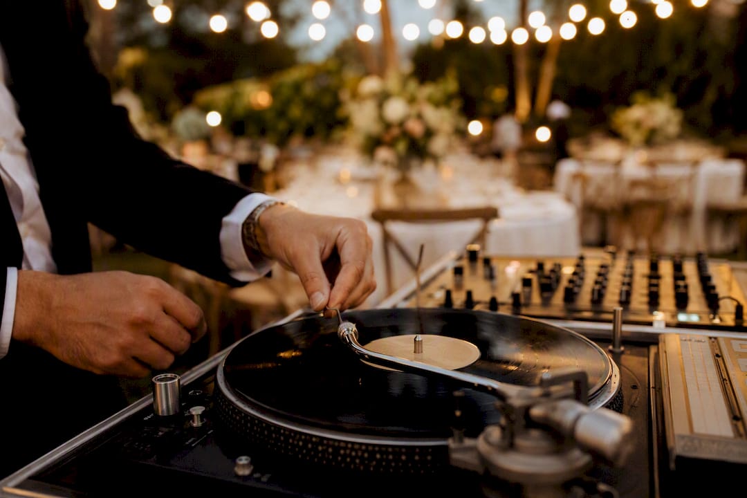DJ hands cueing vinyl record at wedding