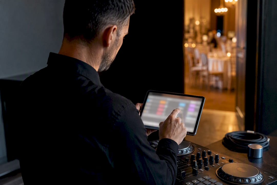 DJ reviewing wedding music choices before reception