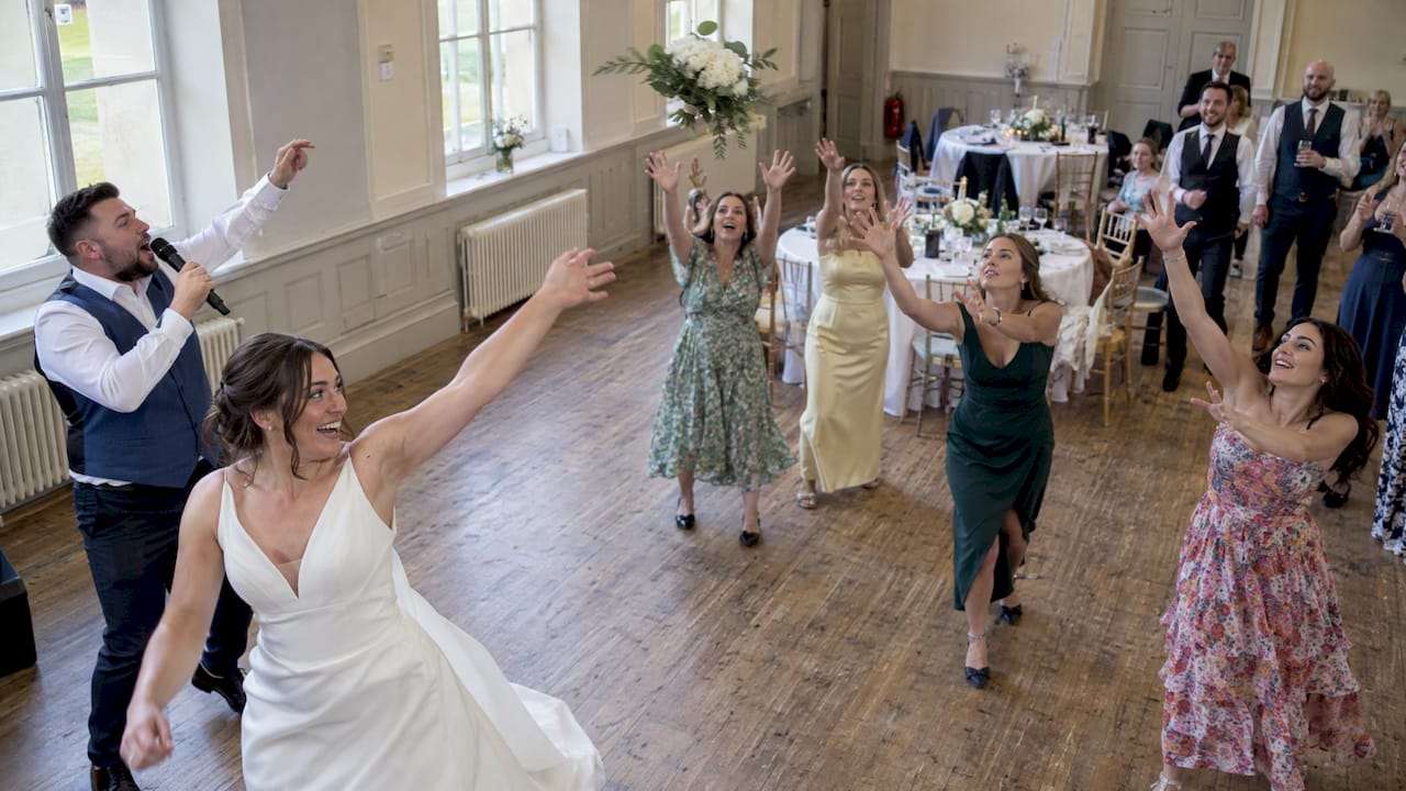 Singing waiter leads lively wedding bouquet toss