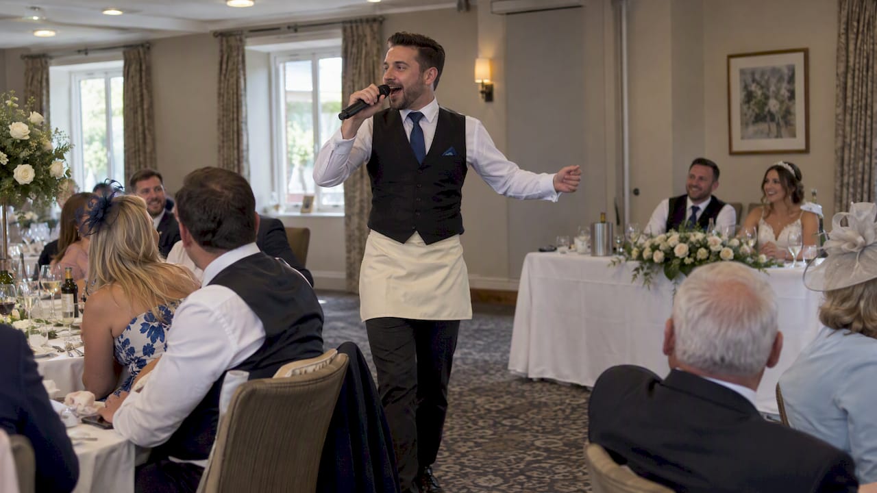 Singing waiter surprising wedding guests