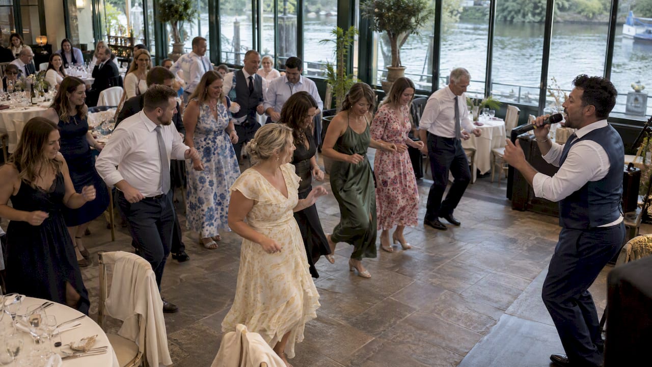 Dinner guests joining a singing waiter’s dance