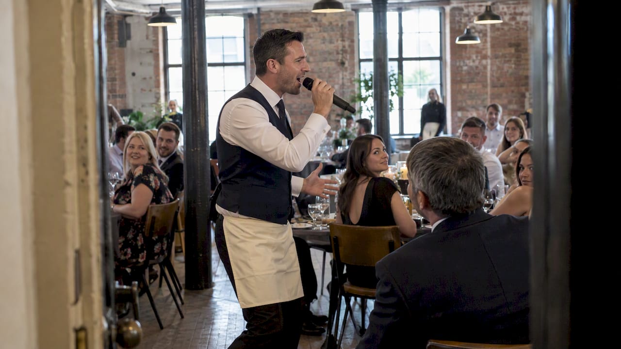 Singing waiter surprises guests at corporate dinner
