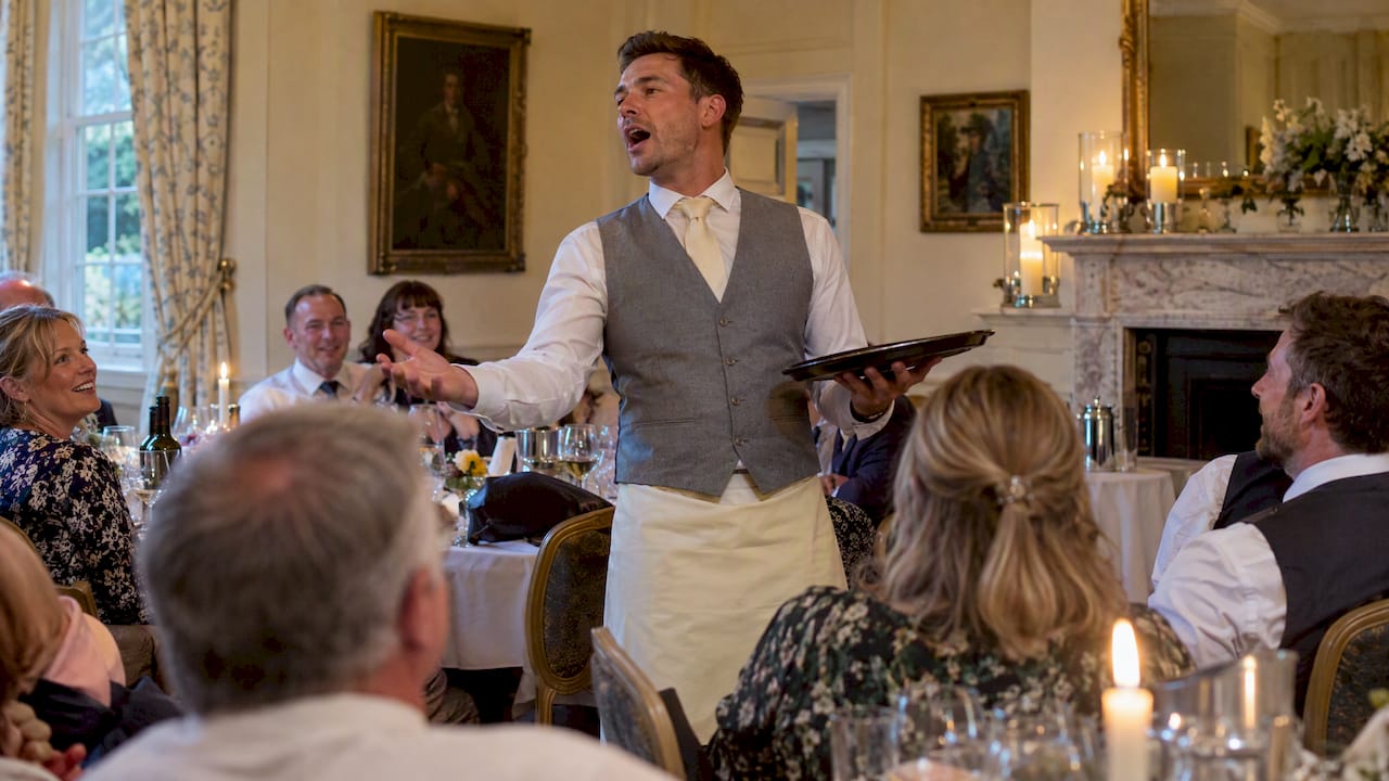 Singing waiter surprises guests at dinner